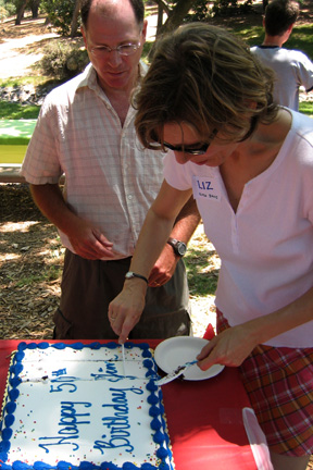 Liz cuts the cake