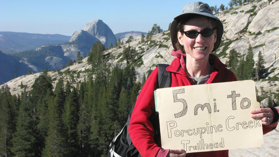 Liz holds our hitch-hiking sign