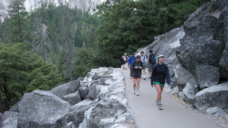 The gang hikes up pavement to the first bridge