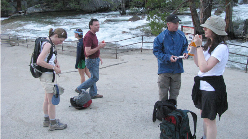 We watch the river flow over the falls