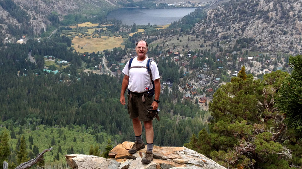 Jim stands on a rocky outcrop