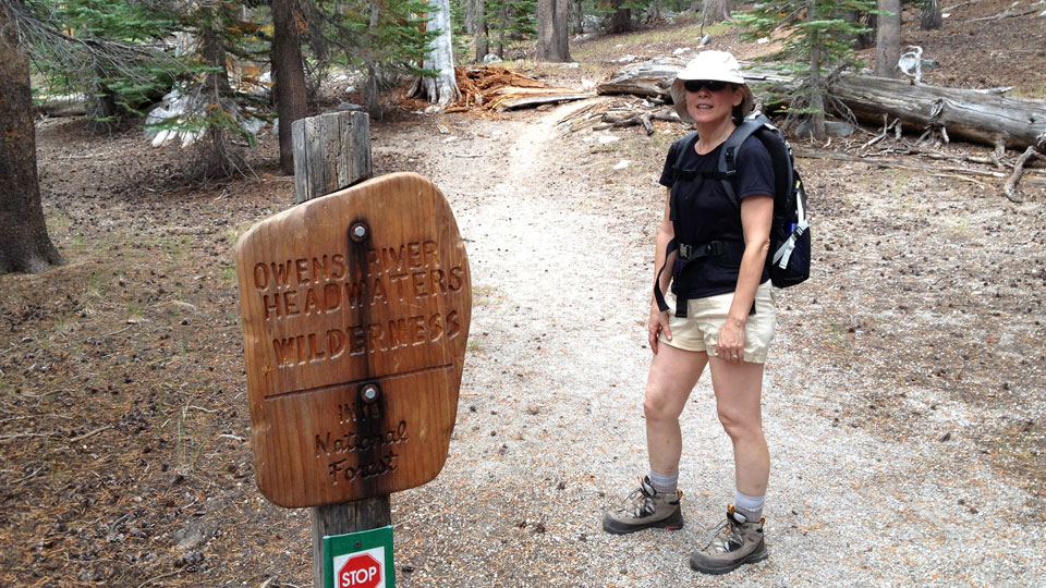 Liz passes the sign designating the area protected wilderness