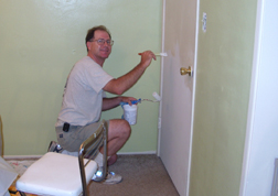 Jim paints the door